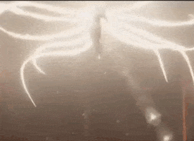 a person is flying through the air with a lot of light coming out of them .