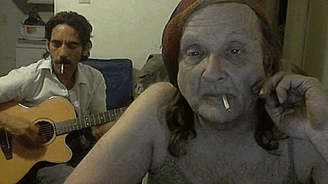 a man is playing a guitar while a woman smoking a cigarette