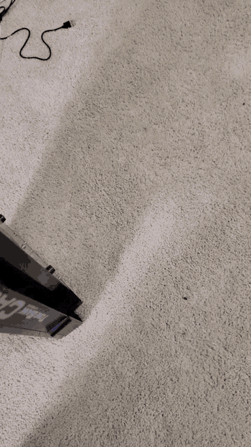 a white carpeted floor with a black box on it that says ' stealth ' on it