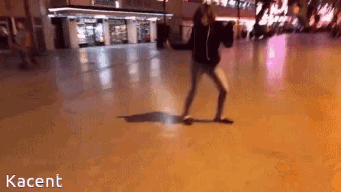 a person is standing on a ice rink with kacent written in the corner