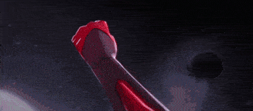 a blurred image of a person in a red shirt