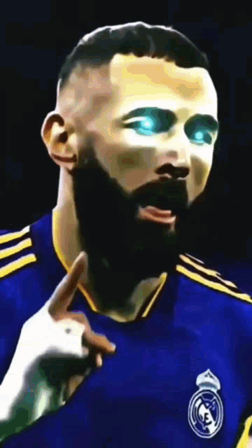 a man with a beard is wearing a blue and yellow jersey with the real madrid logo on it .
