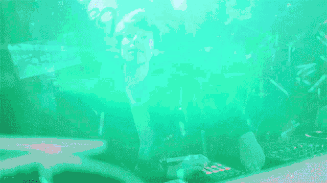 a dj is playing music in front of a crowd and the word moody is visible