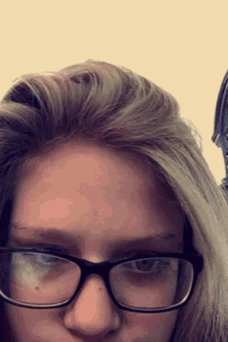 a close up of a woman wearing glasses with a white background