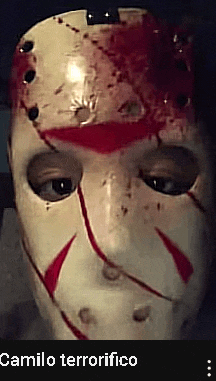 a close up of a person wearing a bloody hockey mask with the words camilo terrorifico below it