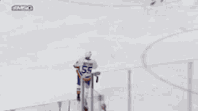 two hockey players are hugging each other and one of them has the number 57 on his jersey
