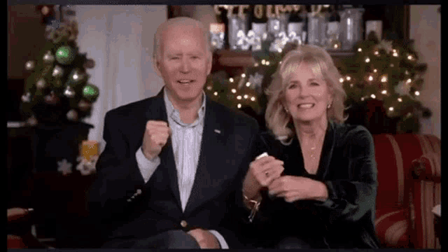 a man and a woman are sitting next to each other on a couch .