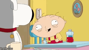 a cartoon character is sitting at a table with a cup of coffee and a bottle of syrup .