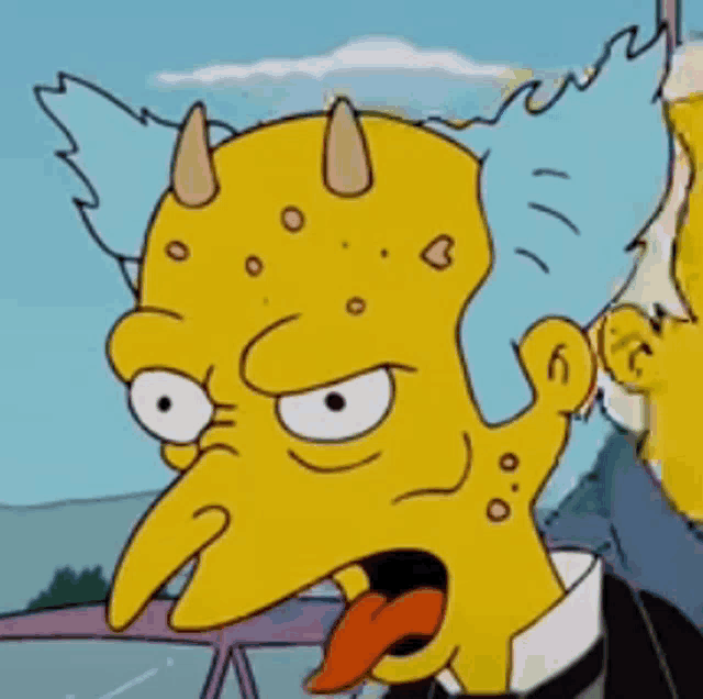 a close up of a cartoon character with horns and a tongue sticking out