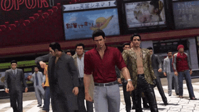a group of men are walking down a street in front of a sign that says popcorn