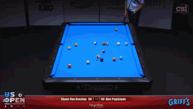 a pool table with a blue cloth and balls on it