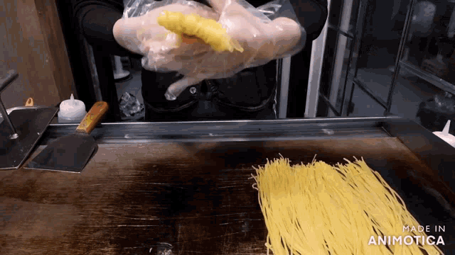 a person is cooking noodles on a stove and the words made in animatica are visible