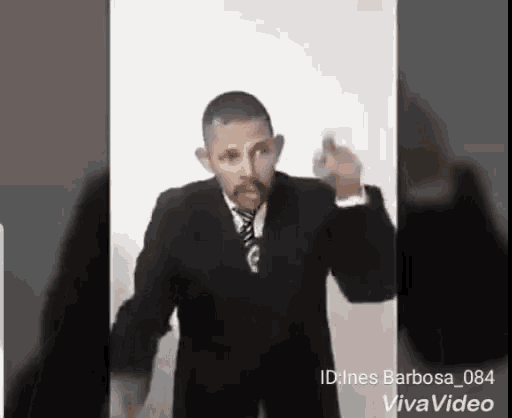 a man in a suit and tie is pointing his finger