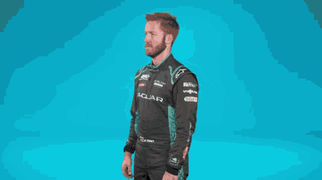 a man is wearing a jaguar racing suit