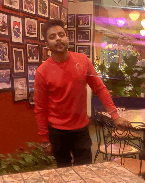 a man in a red shirt with the letter s on his chest
