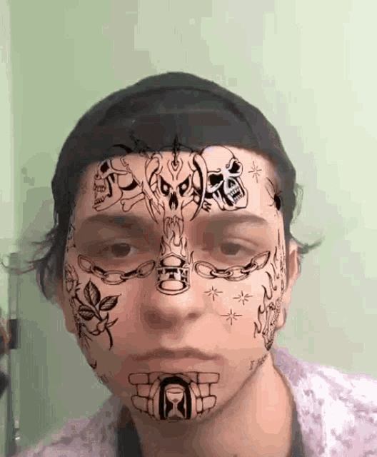 a person has a lot of tattoos on their face including skulls chains and an hourglass