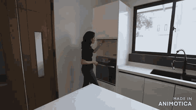 a woman in a kitchen with the words made in animotica on the bottom right