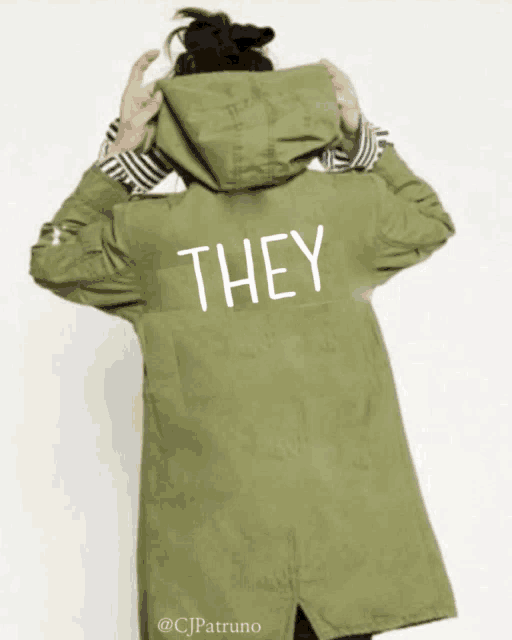 a person wearing a green jacket that says they