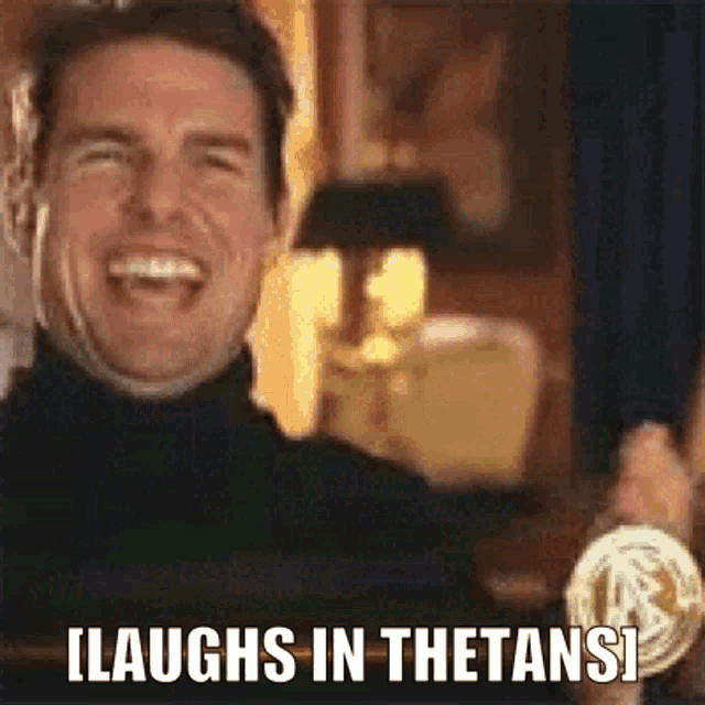 a man is laughing and holding a medal with the words `` laughs in thetans '' written next to him .
