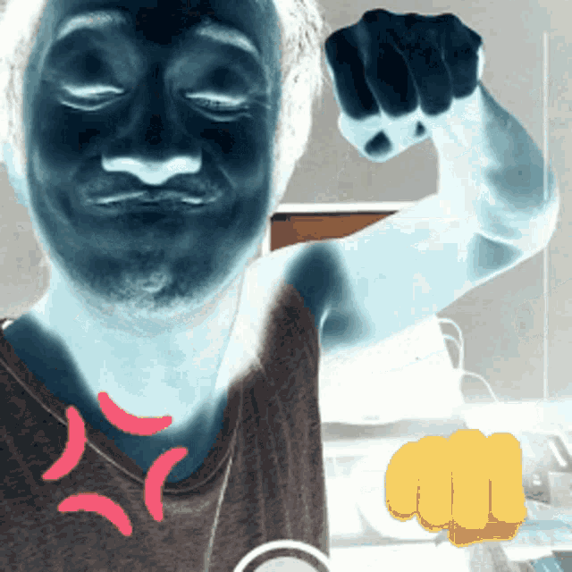 a man with his eyes closed has a yellow fist in his hand