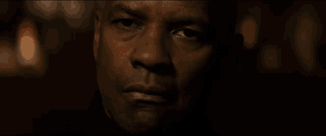 a close up of a man 's face with a blurred background
