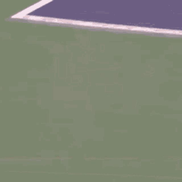a woman is holding a tennis racquet on a court with the number 33 on the wall