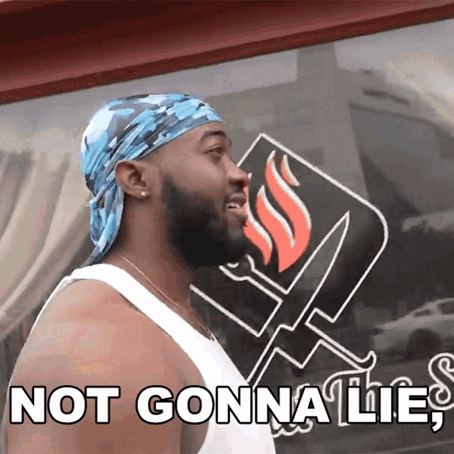 a man with a bandana on his head is standing in front of a window that says not gonna lie