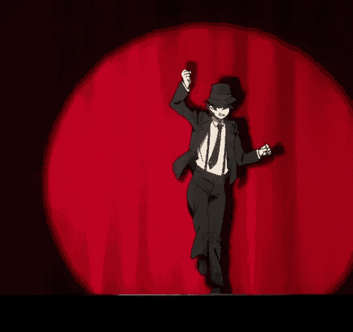 a man in a suit and tie is dancing on a stage
