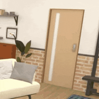 a living room with a couch and a door with a brick wall