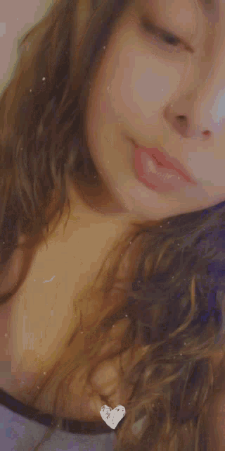 a girl with long blue nails is holding a pen
