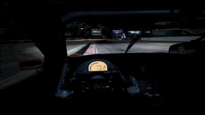 a red and white car is driving down a road