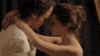 a man and a woman are hugging each other and kissing .