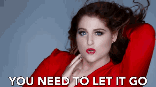 a woman in a red dress with the words you need to let it go above her