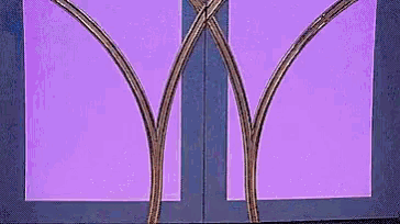 a close up of a purple window with a purple background and a purple door .