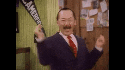 a man in a suit and tie is holding a banner that says camerfield on it .