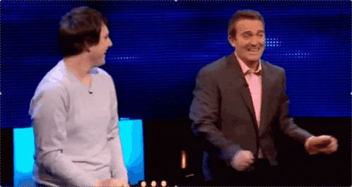 a man in a suit is dancing with another man