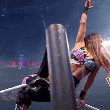a woman in a wrestling ring is wearing a top that says ' smackdown '