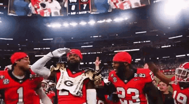 a group of georgia bulldogs football players celebrate their victory