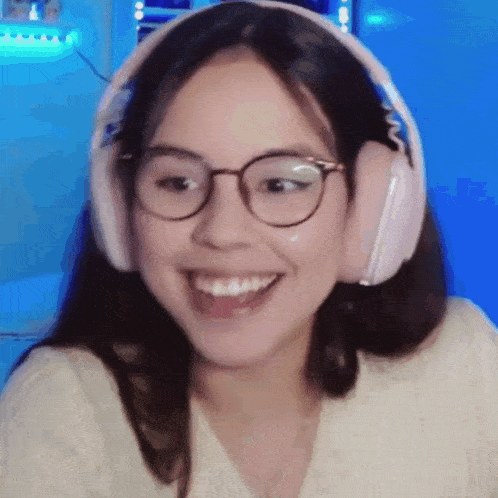 a close up of a woman wearing headphones and glasses .