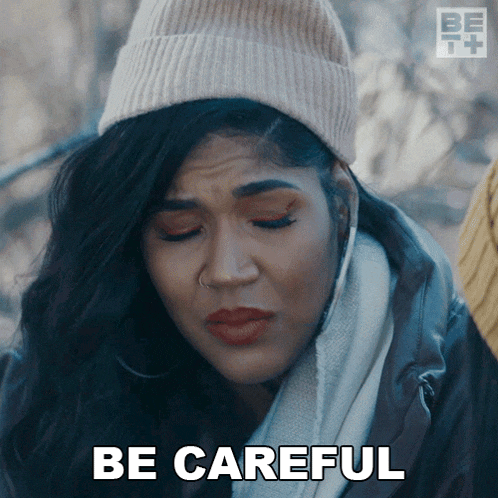 a woman in a beanie says be careful