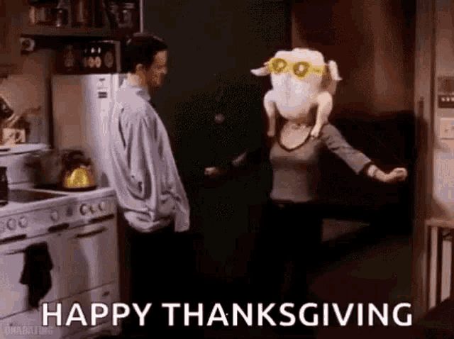 a woman with a turkey head is dancing in a kitchen with a man .