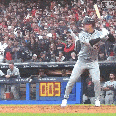 a baseball player with the number 30 on his jersey is about to bat