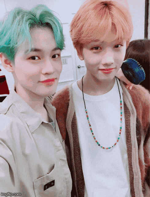 a boy with green hair stands next to another boy with red hair