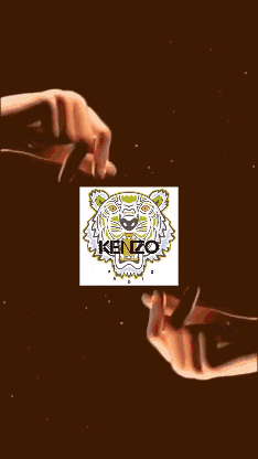 a kenzo logo is surrounded by a circle of sparkles