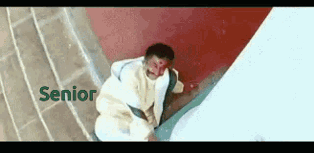 a man laying on a staircase with the word senior in green letters