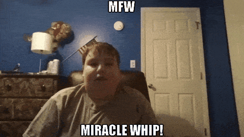 a man sitting in front of a blue wall with the words mfw miracle whip written on it