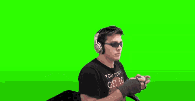 a person is laying on their stomach with their legs up on a green screen .