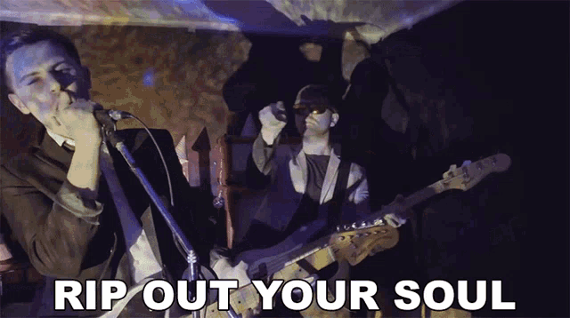 a man singing into a microphone next to a man playing a guitar with the words rip out your soul written below him