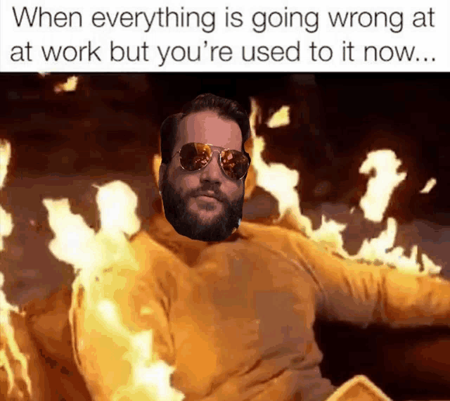 a man with a beard wearing sunglasses and a yellow sweater is on fire
