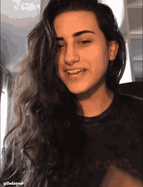 a close up of a woman 's face with the words gifsdayrol below it